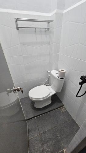 a bathroom with a white toilet in a stall at DYAZA LV Pekanbaru Near Sultan Syarif Kasim Airport and UIR in Pekanbaru