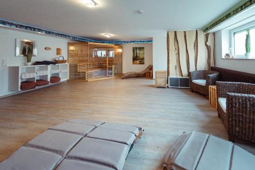 a living room with a couch and chairs in a room at Das Arni´s in Mehlmeisel