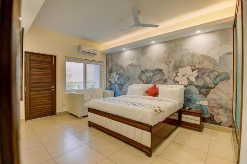a bedroom with a large painting on the wall at Golden Healing Journeys Homestay in Rishīkesh