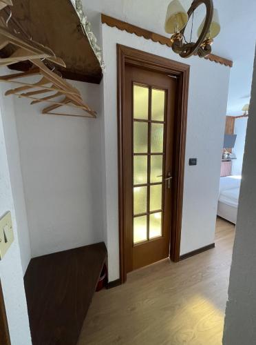 a room with a hallway with a door and a staircase at Hotel Ristorante Il Principe in Claviere
