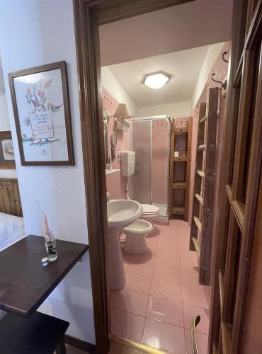 a bathroom with two toilets and a sink and a shower at Hotel Ristorante Il Principe in Claviere