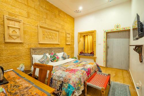 a bedroom with a bed and a table at Garh Meera - A Sensational Boutique Hotel in Jaisalmer