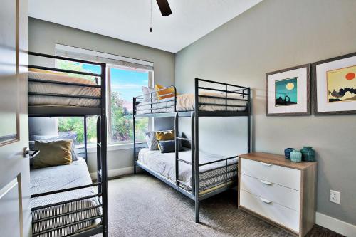 a bedroom with three bunk beds and a window at Entrada at Moab 420 and 424 in Moab