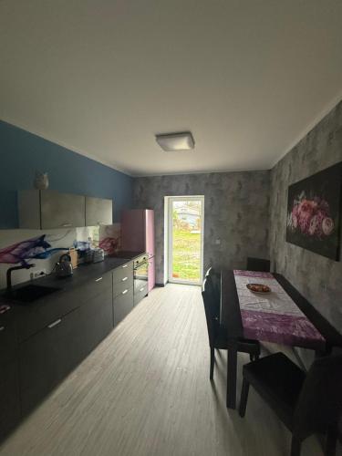 a kitchen with a table and a dining room at Ferienwohnung Parkentin 3 in Bartenshagen-Parkentin