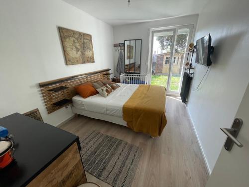 a bedroom with a bed and a television in it at Cozy villa in Aulnay-sous-Bois