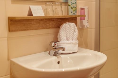 a bathroom sink with a white towel on it at Das Arni´s in Mehlmeisel