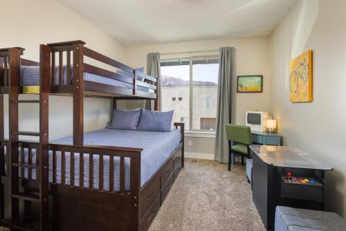 a bedroom with a bunk bed and a desk at Entrada at Moab 442 in Moab