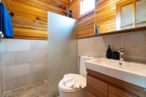 a bathroom with a white toilet and a sink at Tropical Chalet-Style 2BR Villa with Pool Pasak Paradise 2, Bangtao in Laguna Phuket