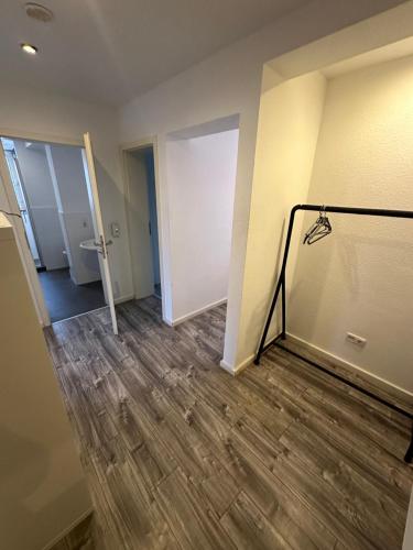an empty room with a door and wooden floor at Schöne Apartments in Königsdorf BM01 bis BM04 in Frechen
