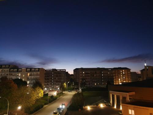 a city at night with cars parked on a street at Dc apartment in Santa Maria Capua Vetere