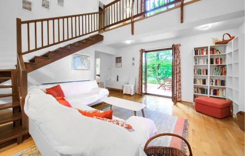 a living room with a white couch and stairs at Beautiful Home In Malinska With Wifi in Malinska