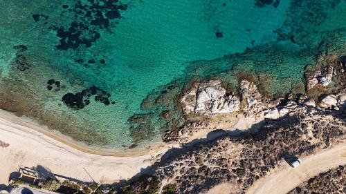 an aerial view of the beach and ocean at Blue Eye Grand Villa Mykonos in Kalafatis