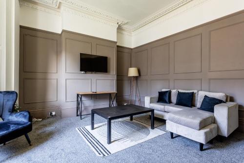 a living room with a couch and a tv at Impressive 6-BR Home in a Prime Sunderland in Sunderland