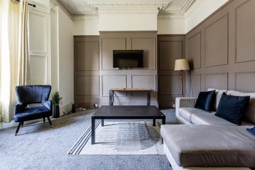 a living room with a couch and a table and a tv at Impressive 6-BR Home in a Prime Sunderland in Sunderland