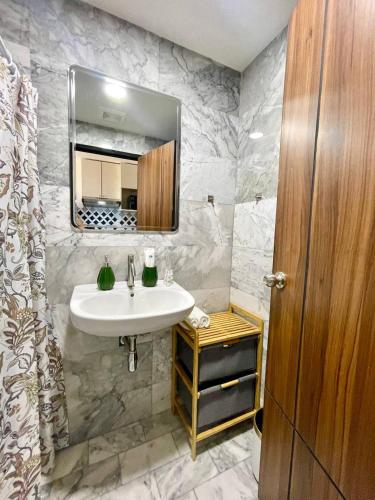 a bathroom with a sink and a mirror at Cozy Room Phuket in Ban Mai Salae