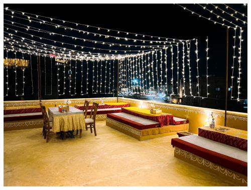 a stage with a table and chairs and lights at Garh Meera - A Sensational Boutique Hotel in Jaisalmer