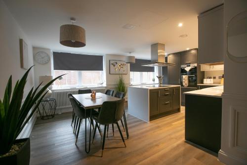 a kitchen with a table and chairs in a kitchen at The Burlington Collection in Sheringham