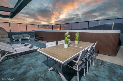 a table and chairs on top of a balcony at Naomi Boutique Suites in Netu'a