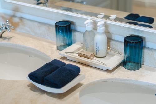 a bathroom with a sink and a mirror and towels at Last Word Long Beach in Kommetjie