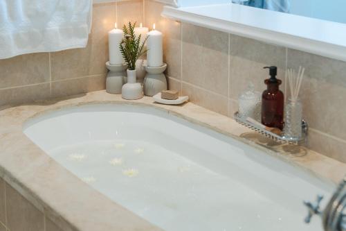 a bath tub with candles on a counter at Last Word Long Beach in Kommetjie
