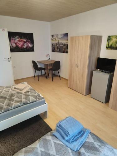 a bedroom with a bed and a table with chairs at Monteurwohnung Marl Brassert - 1OGM in Marl