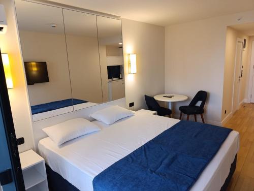 a bedroom with a large white bed and a table at Orbi City D2 - Luxury Hotel - Sea View in Batumi