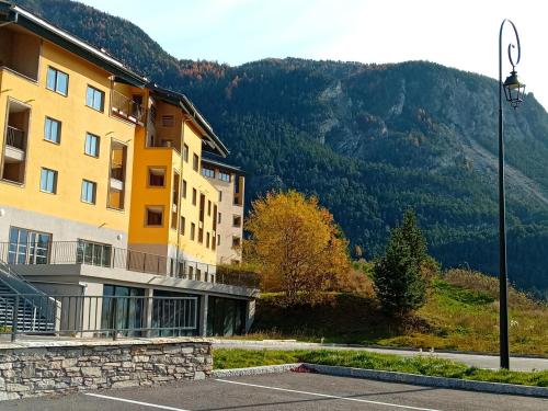 a building with a view of a mountain at Terrasses D 302 PARC NAT VANOISE appart 4 pers in Val Cenis