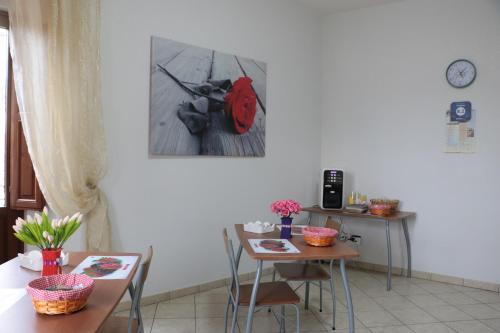 a dining room with a table and a red backpack on the wall at The Maze Vibo B&B in Vibo Valentia