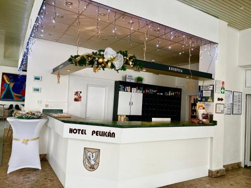 a hotel reception counter with a hotel patrol sign at Hotel Pelikán in Lučenec