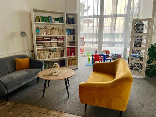 a living room with two couches and a table at Hotel Pelikán in Lučenec