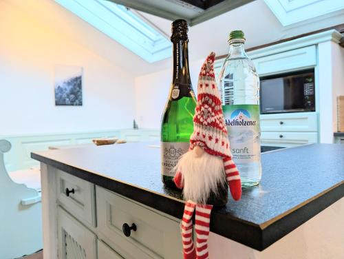 a gnome sitting next to two bottles of wine at Neu! Moderner bayrischer Flair vor Pilatushaus in Oberammergau