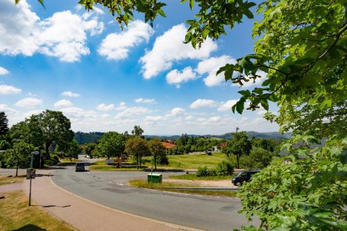 an empty road with a blue sky and clouds at Lieblingsquartier Sankt Andreasberg Studio 9 in Sankt Andreasberg