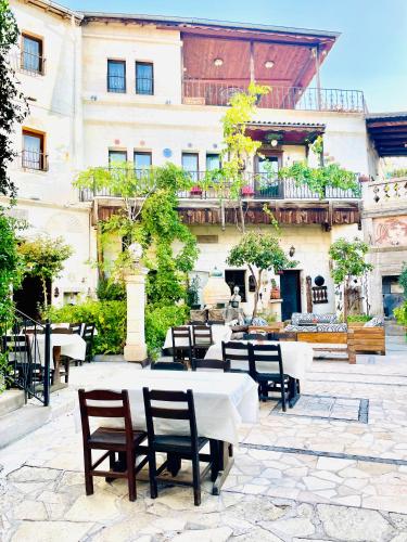 a group of tables and chairs in front of a building at Sofa Hotel in Avanos