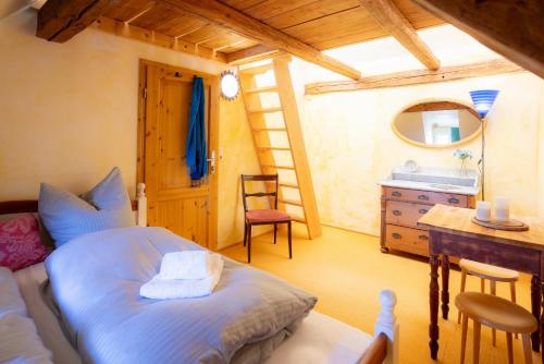 a bedroom with a bed and a sink and a desk at Ferienhaus am Glockenberg in Sankt Andreasberg