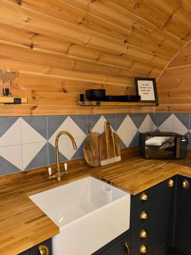 a kitchen with a sink and a counter with a counter top at Isabels Cabin in Banavie