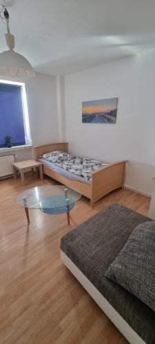 a living room with two beds and a glass table at Monteurwohnung in Marl - Schiller - 1OGR in Marl