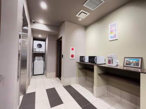 a hospital room with a counter and a refrigerator at Kyoto Jujo 01 京都十条 01 in Kyoto