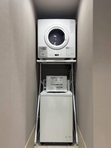a microwave and a refrigerator in a room at Kyoto Jujo 01 京都十条 01 in Kyoto