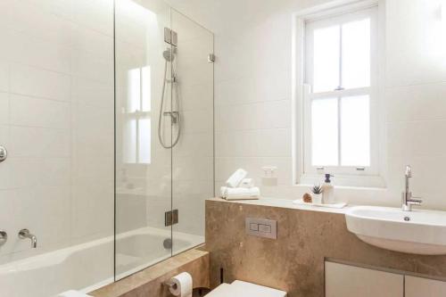 a bathroom with a sink and a tub and a shower at Balmain Wharf l 2 Bedroom Apartment in Sydney