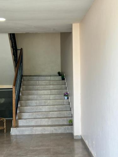 a staircase in a building with a person sitting on it at MAG Palace Hotel in Bissau