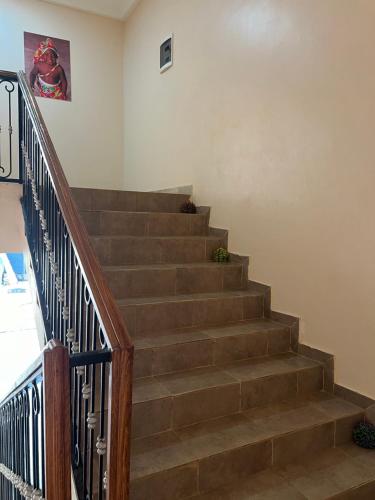 a stairway with brown steps and a railing at MAG Palace Hotel in Bissau