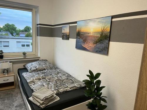 a bedroom with a bed and a window at Monteurwohnung in Marl - Schiller - 1OGL in Marl