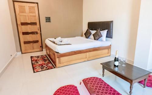 a bedroom with a bed and a table and a table sidx sidx at House Of Brothers in Arambol