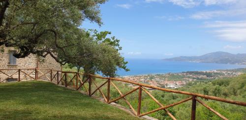 a wooden fence with a view of the water at Casolare Cento Ulivi Luxury & Charme - Villa exclusive use in Ascea