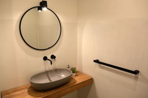 a bathroom with a sink and a mirror on a counter at Casolare Cento Ulivi Luxury & Charme - Villa exclusive use in Ascea