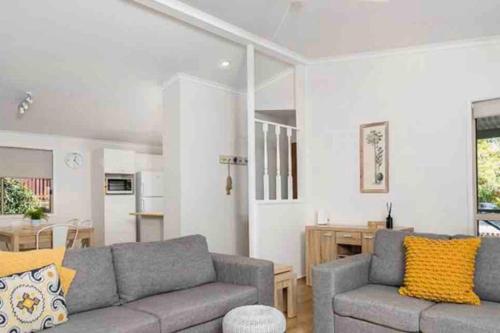 a living room with a couch and a table at NORTH BYRON BEACH HOUSE Surf Sun Sand in South Golden Beach