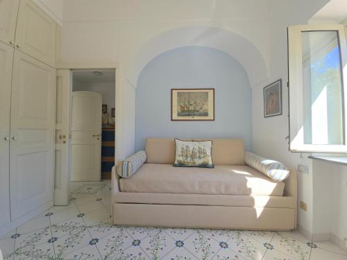 a living room with a couch and a window at La Spiga in Capri