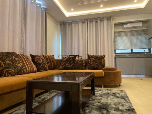 a living room with a couch and a coffee table at Seven Heaven Plaza in Serekunda