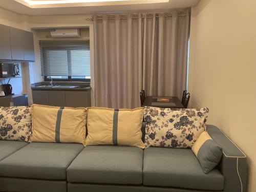 a couch with pillows in a living room at Seven Heaven Plaza in Serekunda