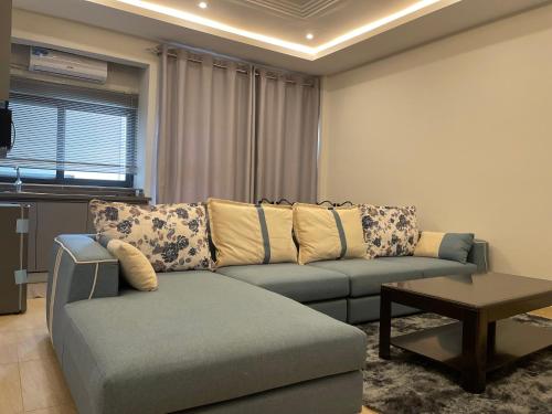a living room with a couch and a table at Seven Heaven Plaza in Serekunda